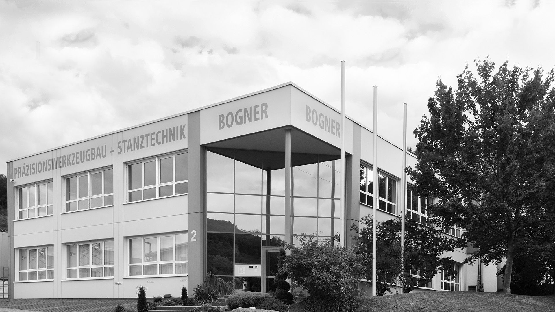 Exterior view of a precision engineering building with large windows and a modern design